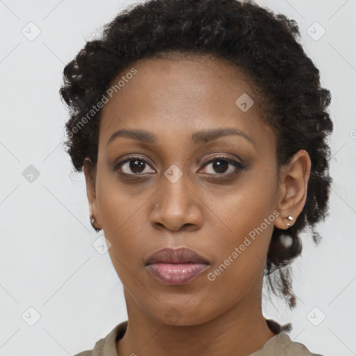 Joyful black young-adult female with long  brown hair and brown eyes