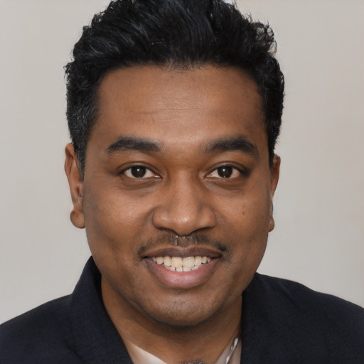 Joyful black young-adult male with short  black hair and brown eyes