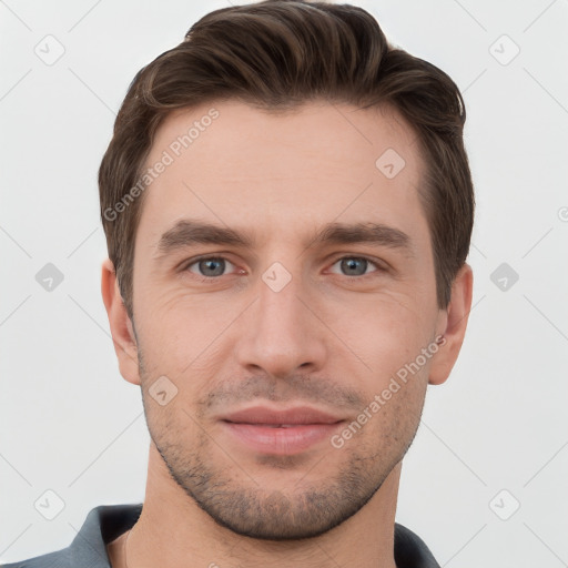 Joyful white young-adult male with short  brown hair and grey eyes