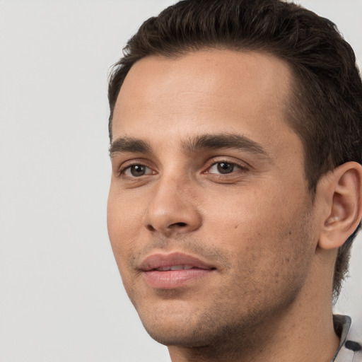 Joyful white young-adult male with short  black hair and brown eyes