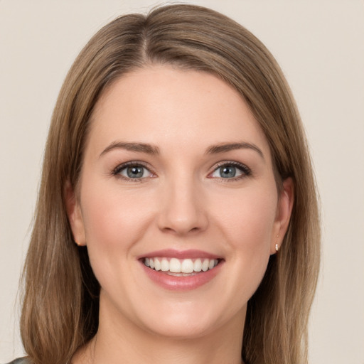 Joyful white young-adult female with long  brown hair and green eyes