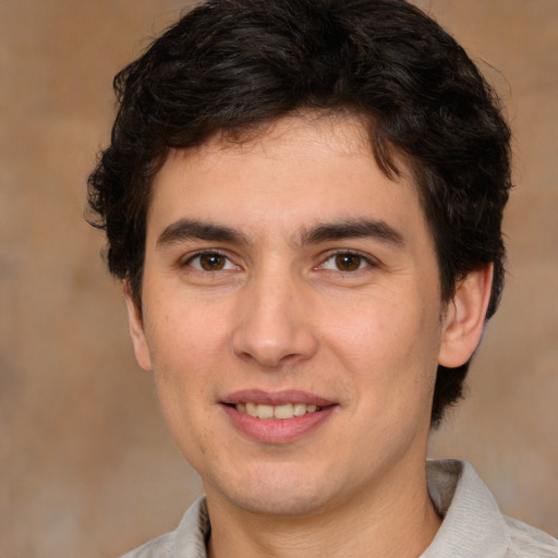 Joyful white young-adult male with medium  brown hair and brown eyes