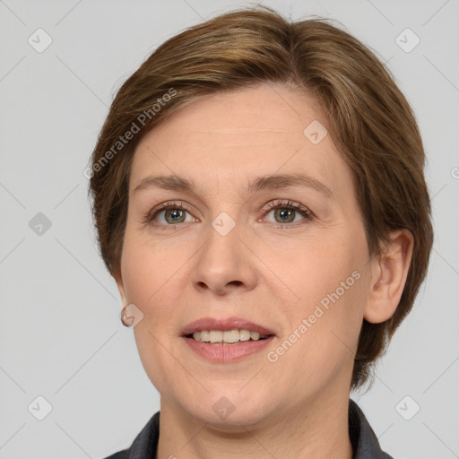 Joyful white adult female with medium  brown hair and grey eyes