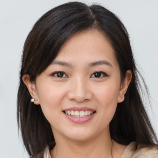 Joyful asian young-adult female with medium  brown hair and brown eyes