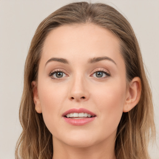 Joyful white young-adult female with long  brown hair and grey eyes