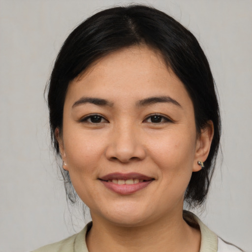 Joyful latino young-adult female with medium  black hair and brown eyes