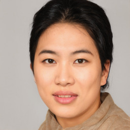 Joyful asian young-adult female with short  brown hair and brown eyes