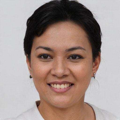 Joyful asian young-adult female with short  black hair and brown eyes