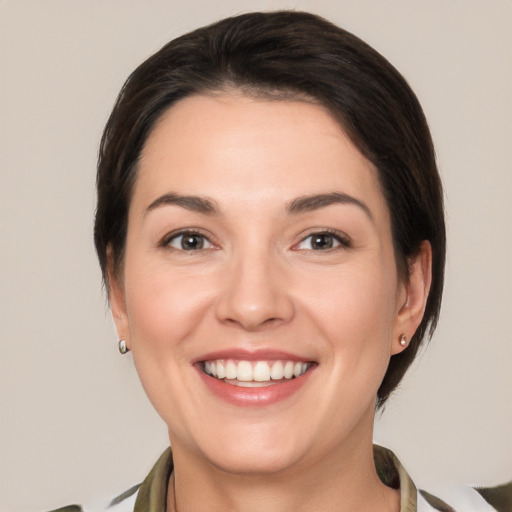 Joyful white young-adult female with medium  brown hair and brown eyes