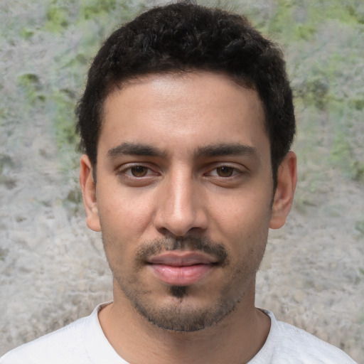 Joyful white young-adult male with short  black hair and brown eyes