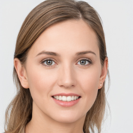 Joyful white young-adult female with long  brown hair and grey eyes