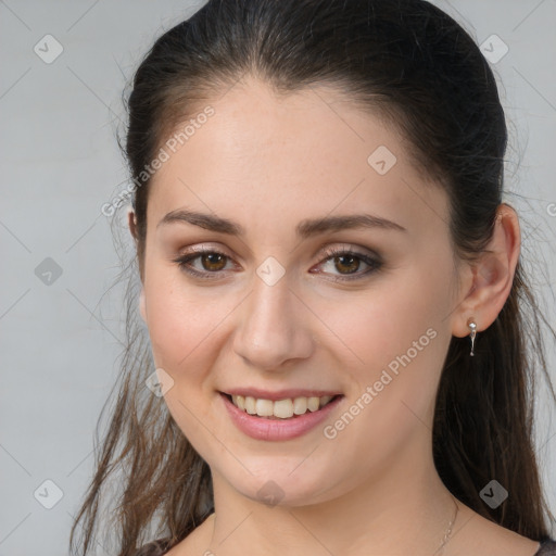 Joyful white young-adult female with long  brown hair and brown eyes