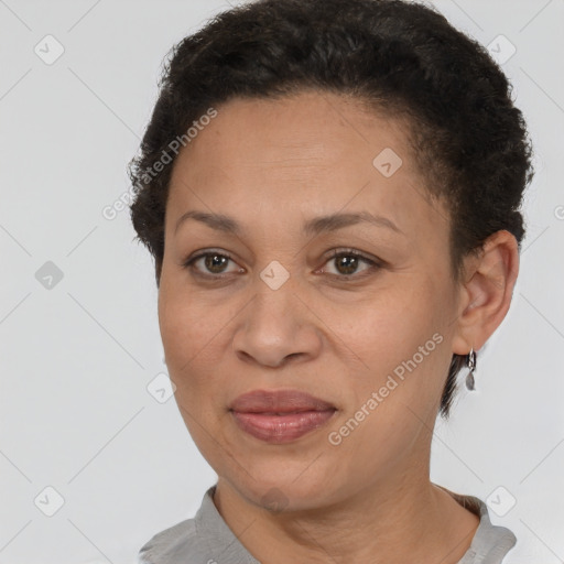 Joyful latino adult female with short  brown hair and brown eyes