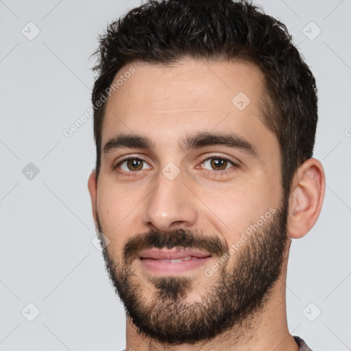 Joyful white young-adult male with short  black hair and brown eyes