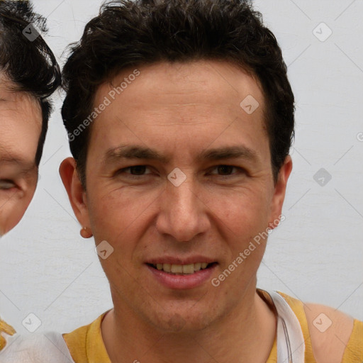 Joyful white adult male with short  brown hair and brown eyes