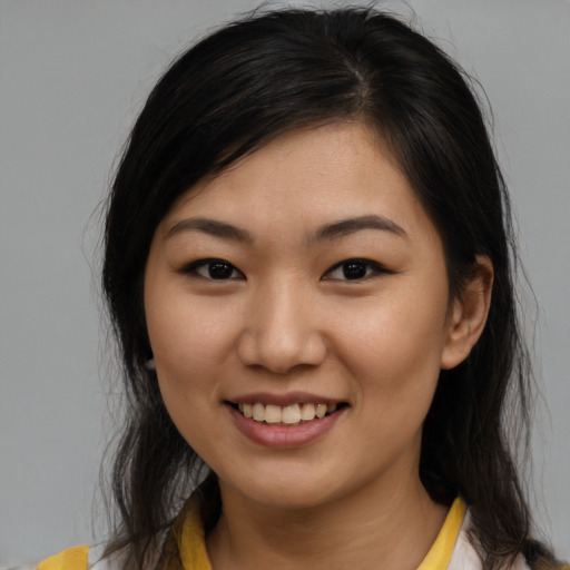 Joyful asian young-adult female with medium  brown hair and brown eyes