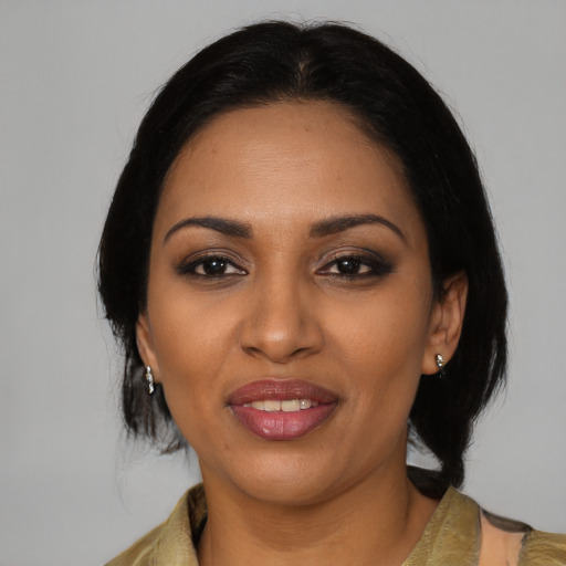 Joyful black young-adult female with medium  black hair and brown eyes
