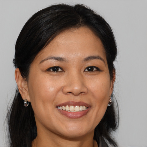 Joyful asian young-adult female with medium  brown hair and brown eyes