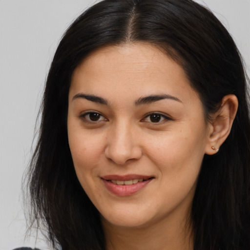 Joyful asian young-adult female with long  brown hair and brown eyes