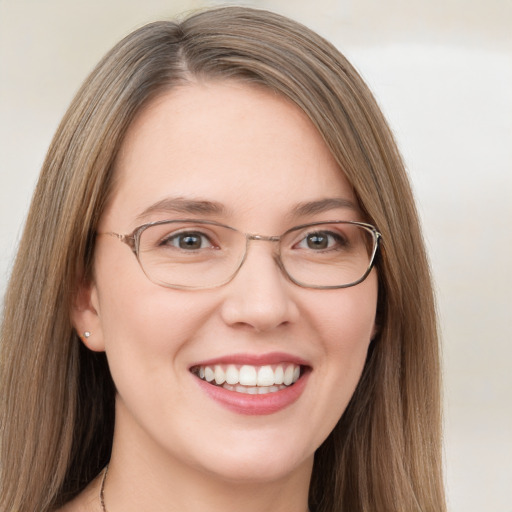 Joyful white young-adult female with long  brown hair and green eyes