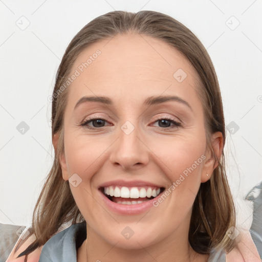 Joyful white young-adult female with medium  brown hair and grey eyes