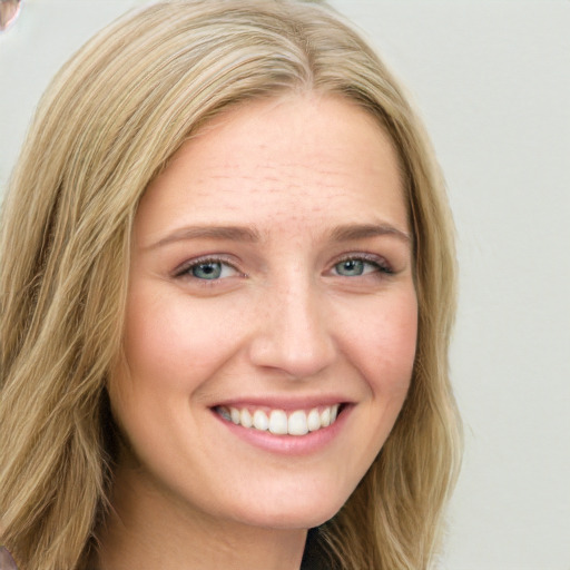 Joyful white young-adult female with long  brown hair and blue eyes