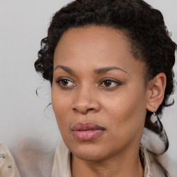 Joyful black young-adult female with medium  brown hair and brown eyes