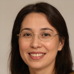 Joyful white adult female with long  brown hair and brown eyes