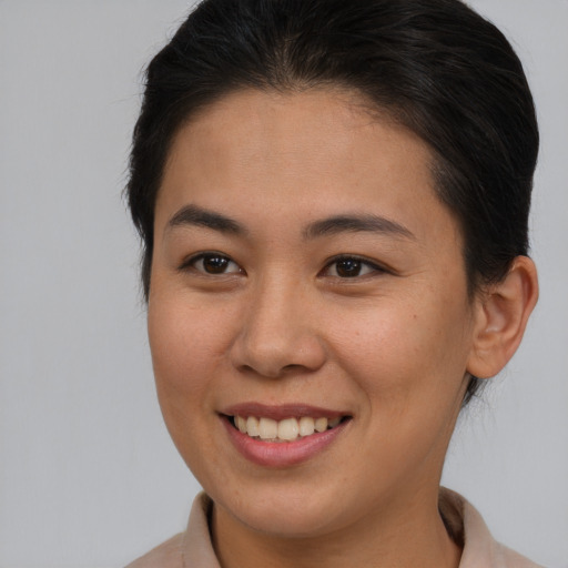 Joyful asian young-adult female with medium  brown hair and brown eyes