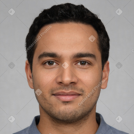 Joyful latino young-adult male with short  black hair and brown eyes