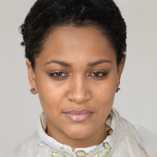 Joyful black young-adult female with short  brown hair and brown eyes
