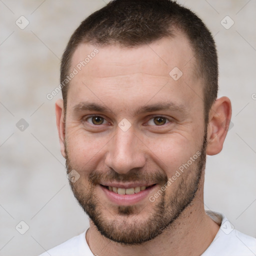 Joyful white young-adult male with short  brown hair and brown eyes