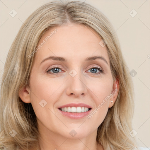 Joyful white young-adult female with long  brown hair and blue eyes