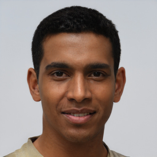 Joyful black young-adult male with short  black hair and brown eyes