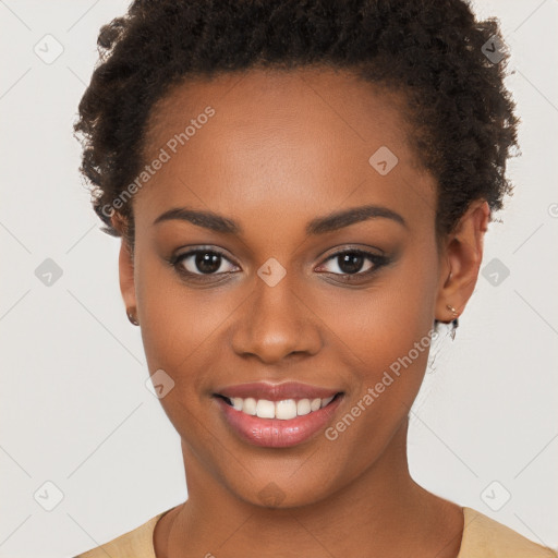 Joyful black young-adult female with short  brown hair and brown eyes