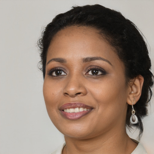 Joyful black young-adult female with medium  black hair and brown eyes