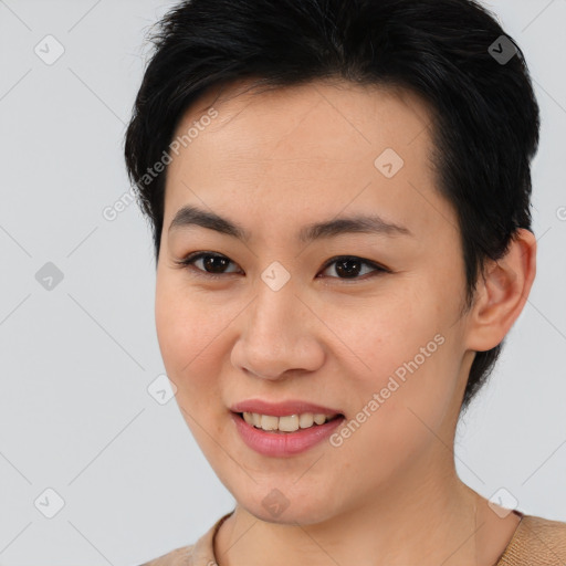 Joyful asian young-adult female with short  brown hair and brown eyes