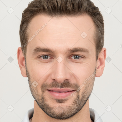 Joyful white young-adult male with short  brown hair and grey eyes