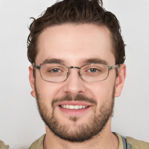 Joyful white young-adult male with short  brown hair and green eyes