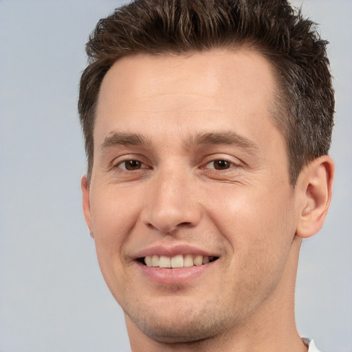 Joyful white young-adult male with short  brown hair and brown eyes