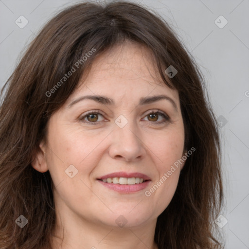 Joyful white adult female with long  brown hair and brown eyes