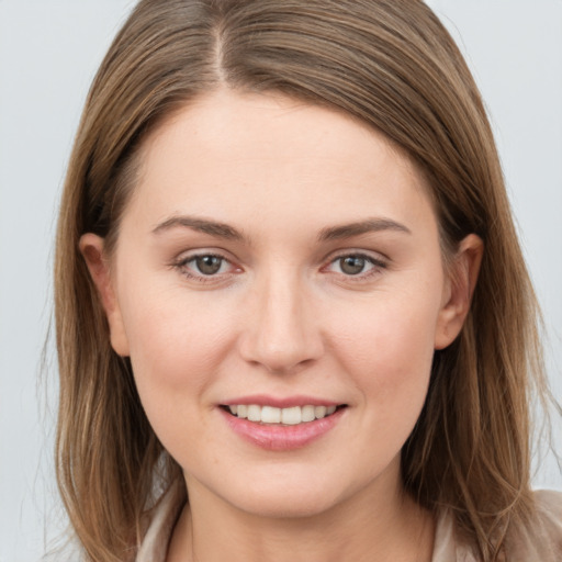 Joyful white young-adult female with long  brown hair and grey eyes