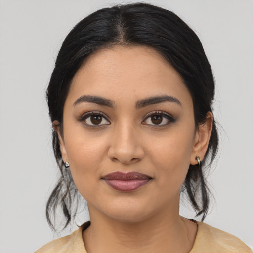 Joyful latino young-adult female with medium  black hair and brown eyes