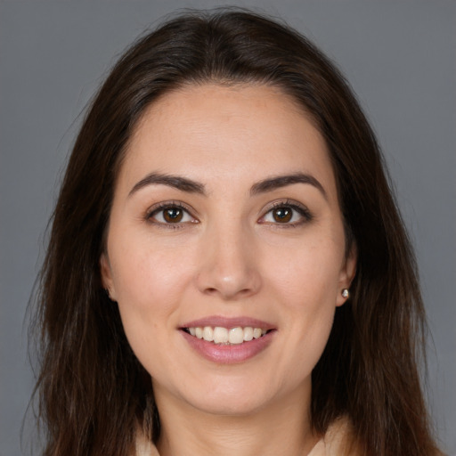 Joyful white young-adult female with long  brown hair and brown eyes