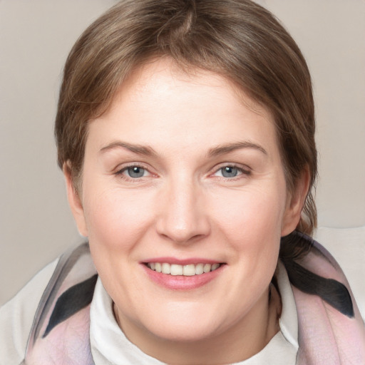 Joyful white young-adult female with medium  brown hair and grey eyes