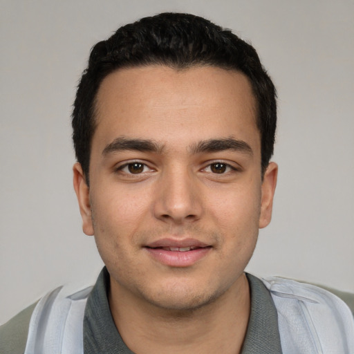 Joyful white young-adult male with short  black hair and brown eyes
