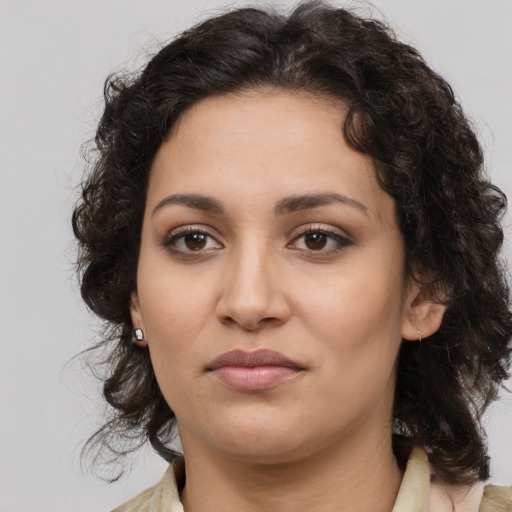 Joyful latino young-adult female with medium  brown hair and brown eyes