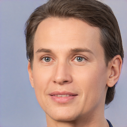 Joyful white adult male with short  brown hair and brown eyes