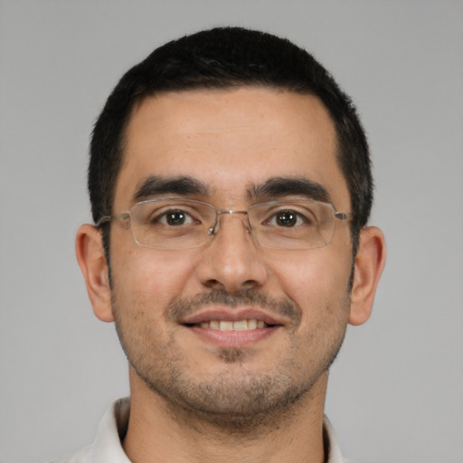 Joyful latino young-adult male with short  black hair and brown eyes