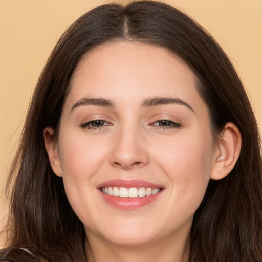 Joyful white young-adult female with long  brown hair and brown eyes